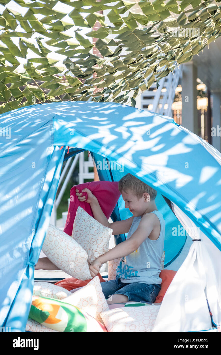 Portrait of cute boy inside tent at backyard Stock Photo
