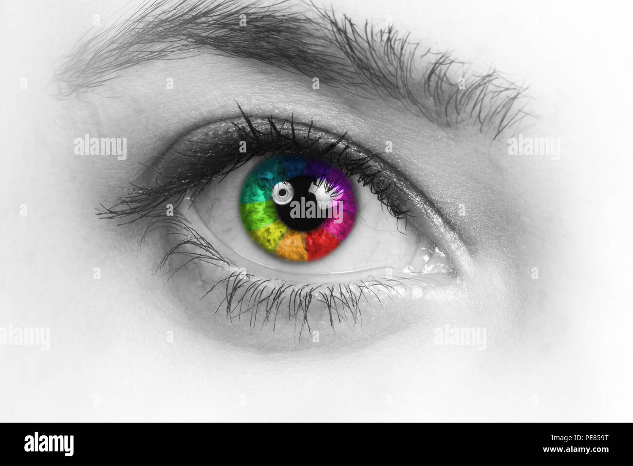 Girl colorful and natural rainbow eye on white background. Stock Photo