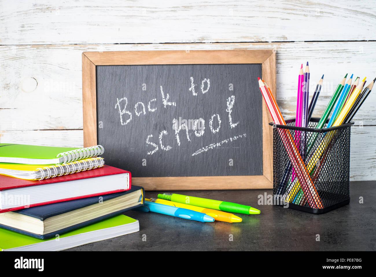 Variation of colored chalk sticks on blackboard. Copy space. Back to school  Stock Photo