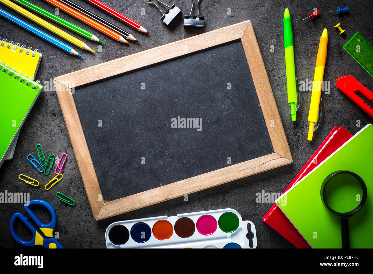 Blackboard with School and office supplies on black background. Top ...