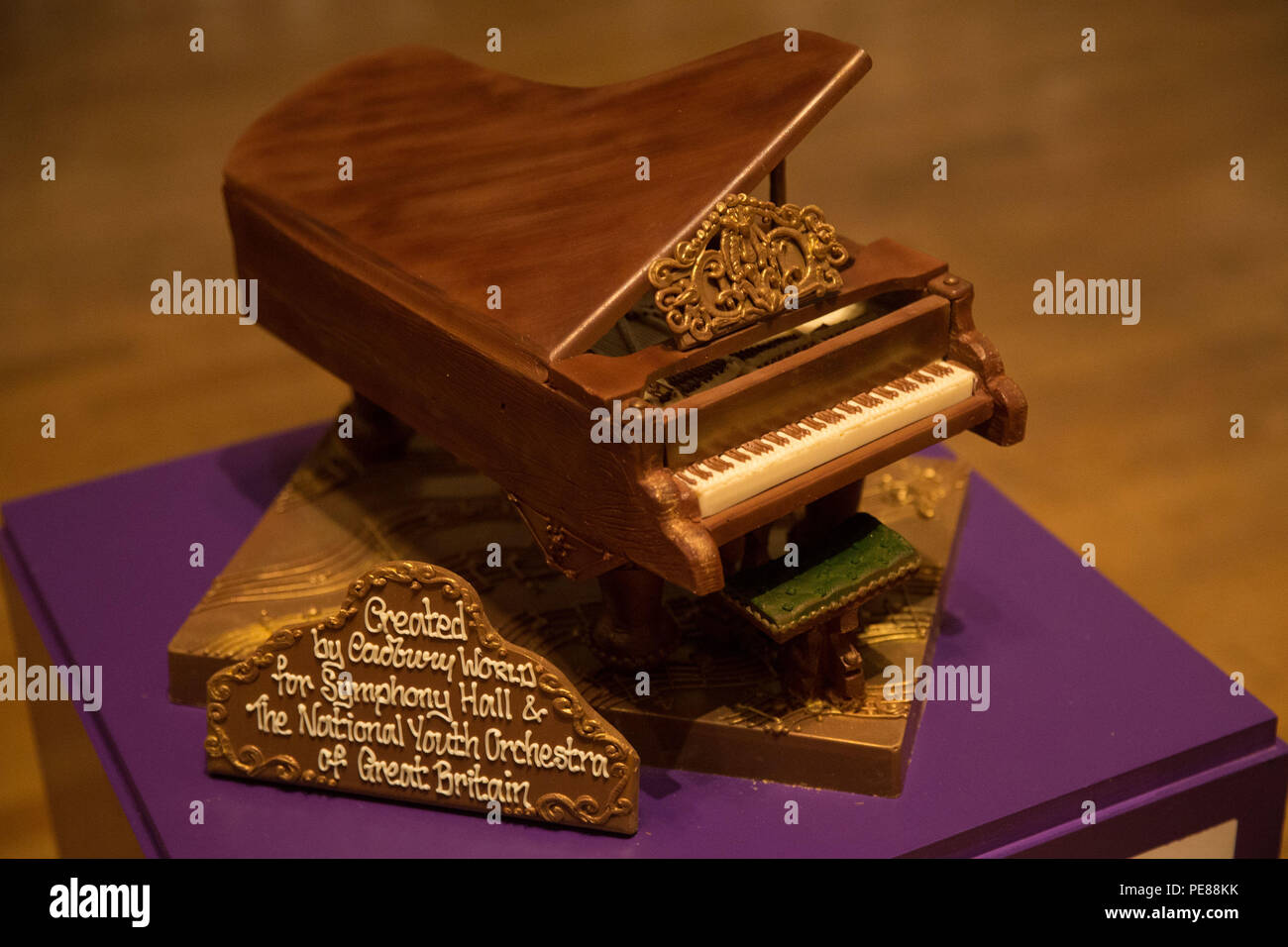 A Cadbury World chocolate grand piano on stage at Birmingham's Symphony Hall, Broad Street, Birmingham. The piano weighing 2kg and made from 44 standard bars of Dairy Milk was a gift to Symphony Hall and the National Youth Orchestra of Great Britain. Stock Photo