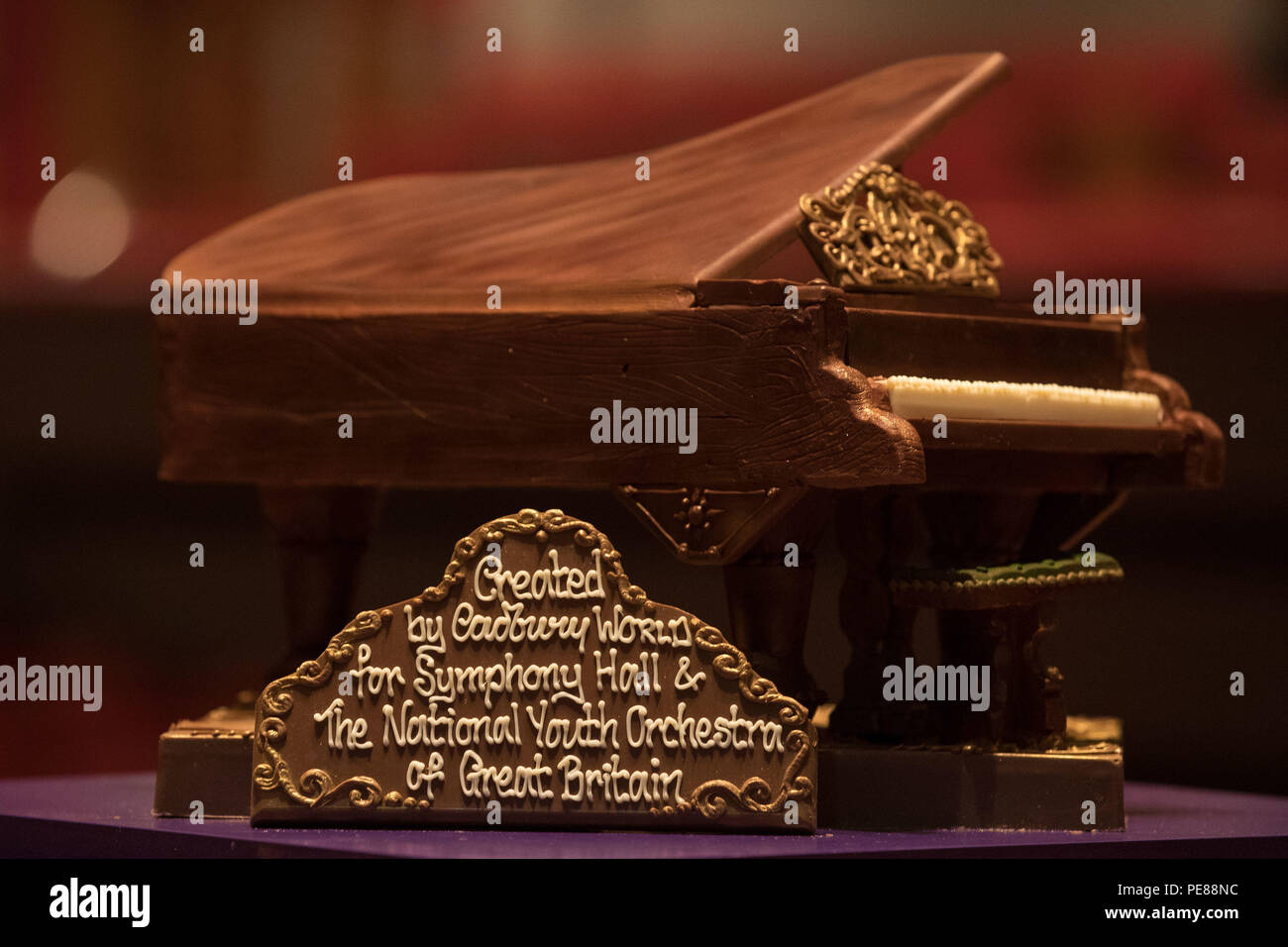 A Cadbury World chocolate grand piano on stage at Birmingham's Symphony Hall, Broad Street, Birmingham. The piano weighing 2kg and made from 44 standard bars of Dairy Milk was a gift to Symphony Hall and the National Youth Orchestra of Great Britain. Stock Photo