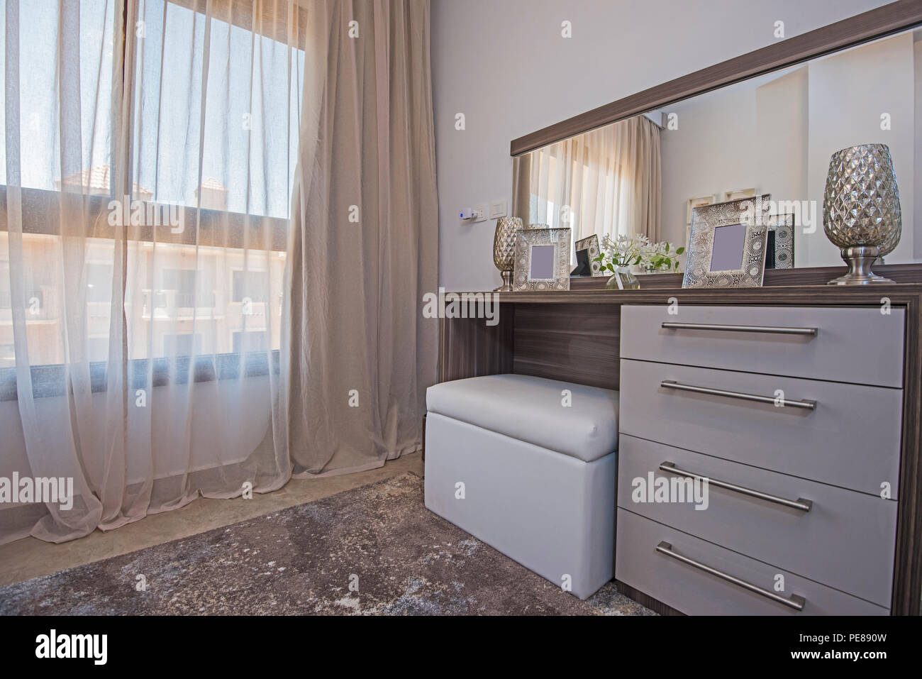 Interior design decor furnishing of luxury show home bedroom with dressing table and window Stock Photo