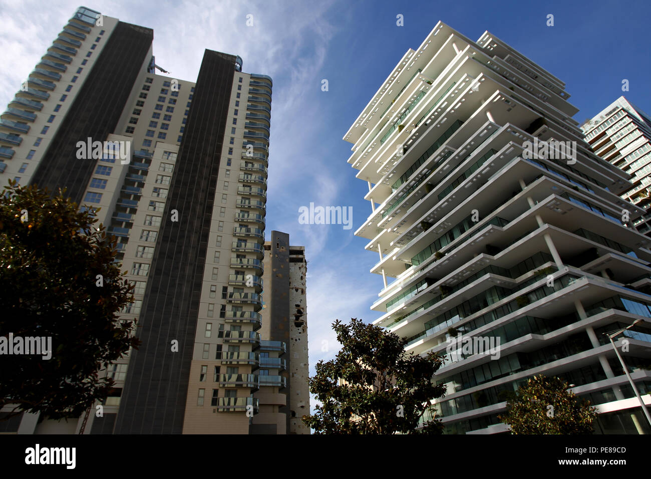 Shell-pocked Holiday Inn hotel is seen near plush buildings at what used to be one of Beirut’s killing fields during Lebanon’s 1975-1990 civil war. Stock Photo