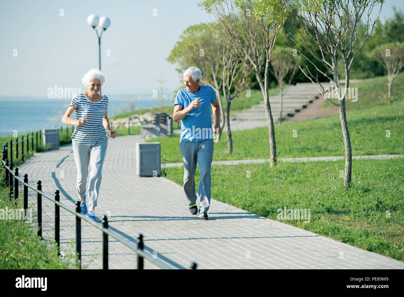 Senior Couple Running Outdoors Stock Photo
