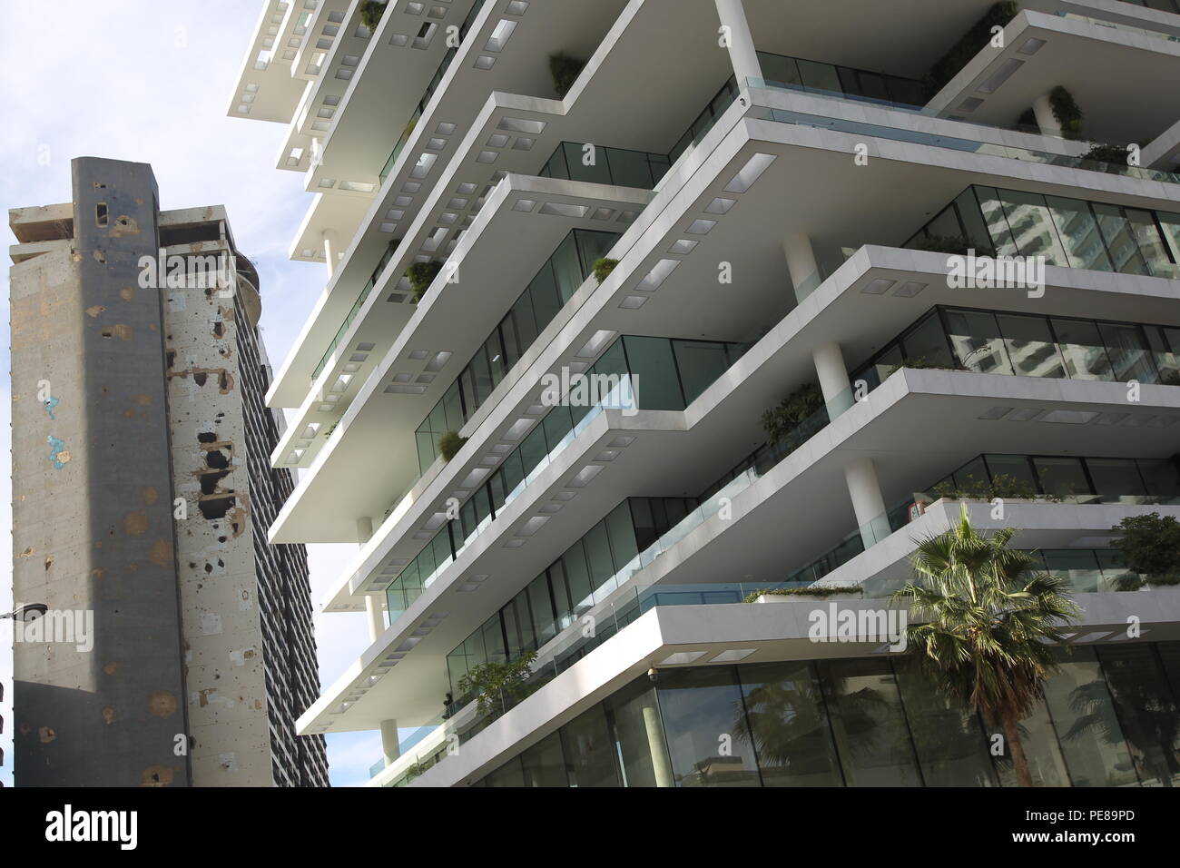 Shell-pocked Holiday Inn hotel is seen near plush buildings at what used to be one of Beirut’s killing fields during Lebanon’s 1975-1990 civil war. Stock Photo