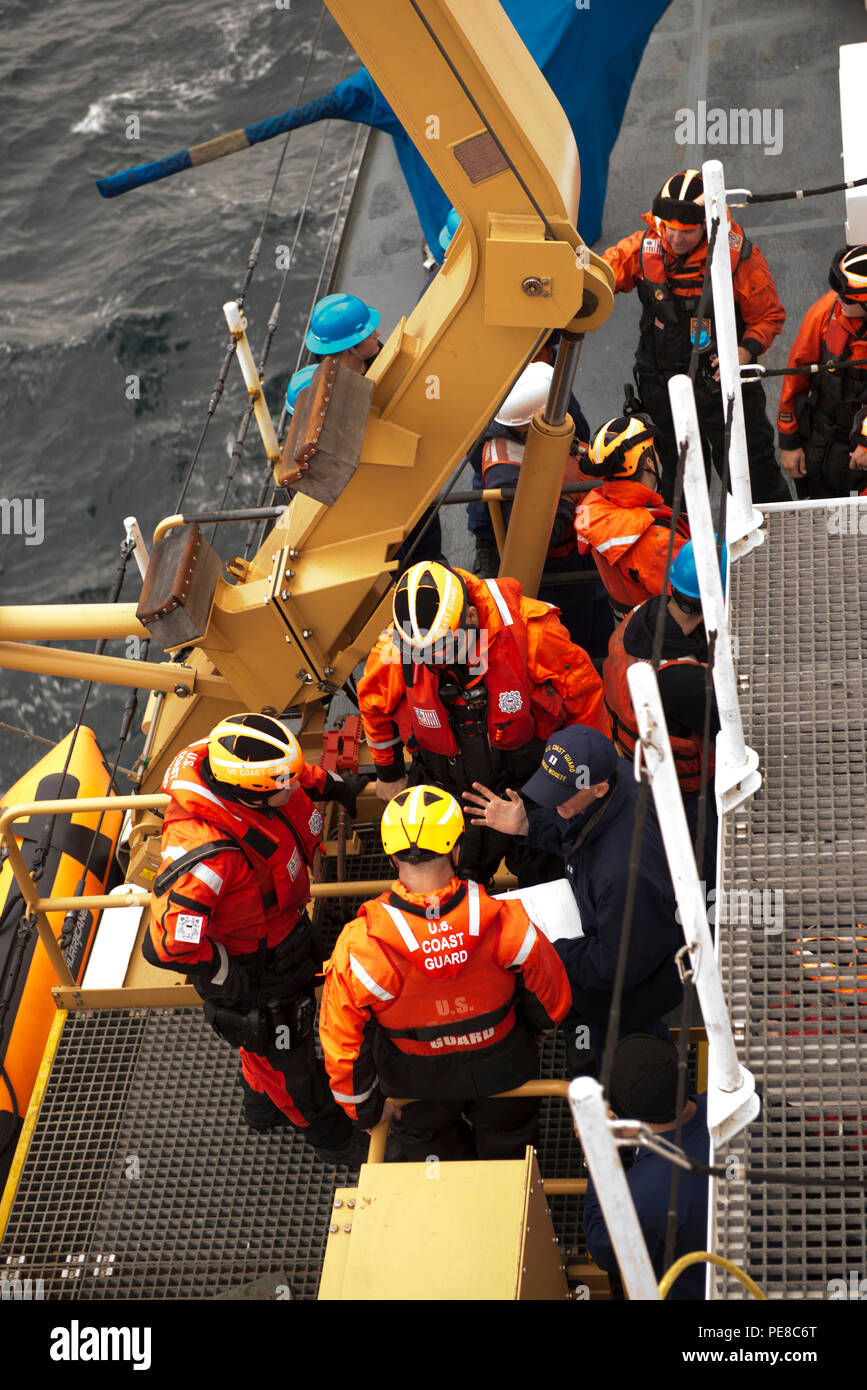 Lt. Steven Baldovsky, operations officer Coast Guard Cutter Midgett, discusses the living marine resources boarding operation with the Midgett's boarding team prior to them getting underway on the cutter's small boat, in the Pacific Ocean, Oct. 11, 2015. The Midgett was conducting LMR boardings to ensure commercial fishermen where fishing within season and had proper safety gear. (U.S. Coast Guard photo by Petty Officer 1st Class Levi Read) Stock Photo