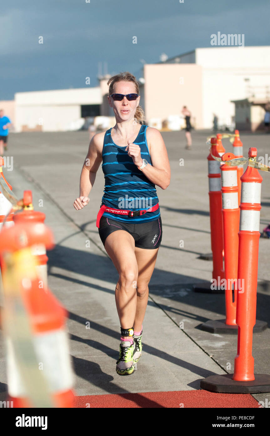 MARINE CORPS BASE HAWAII — Race participant Petty Officer 3rd Class Jessica  Treu crosses the finish line during the 12th annual Splash \u0026 Dash Biathlon  aboard Marine Corps Base Hawaii, Oct. 3,, image size:863x1390