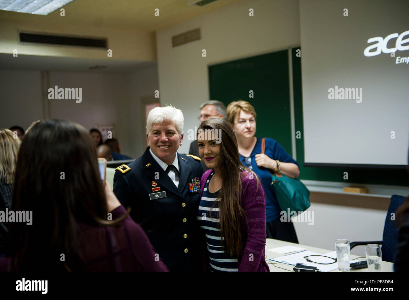 U.S. Army Brig. Gen. Giselle Wilz, NATO Headquarters Sarajevo commander, poses with a student for a photo during a visit to the University of Tuzla's Faculty of Law in Tuzla, Bosnia and Herzegovina Oct. 26, 2015. Wilz visited the university to meet with students and discuss the benefits of being a member of NATO. (U.S. Air Force photo by Staff Sgt. Clayton Lenhardt/Released) Stock Photo