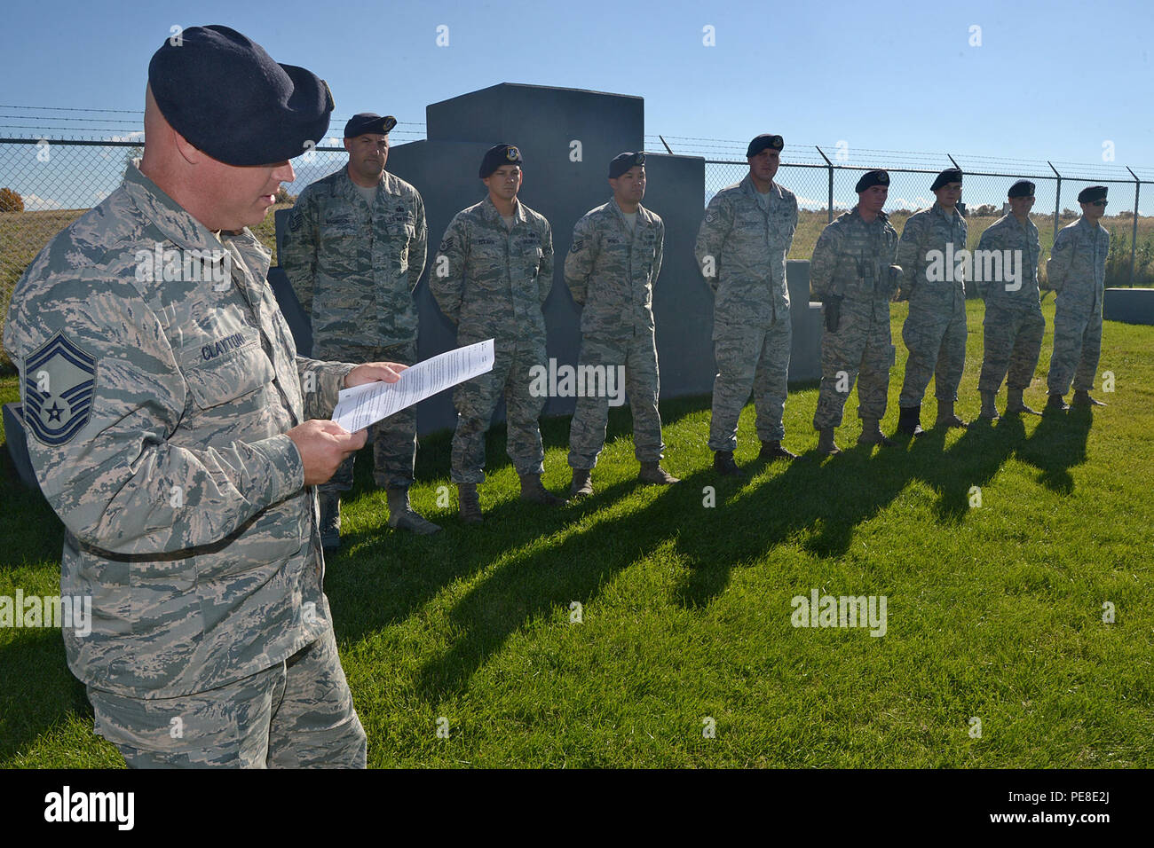 Senior Master Sgt. Douglas F. Clayton, 75th Security Forces Squadron, reads a U.S. Forest Service letter of recognition to 75th SFS Airmen at Hill Air Force Base, Utah, Oct. 26, 2015. The Airmen, military working dog handlers, were training with the Forest Service in the Uinta-Wasatch-Cache National Forest when an emergency medical call was received. To aid an injured person, they carried packs, a litter and other supplies more than two miles at elevations of 7,500 feet. Once at the scene, they coordinated a safe landing for an emergency helicopter and then carried the victim to the helicopter Stock Photo