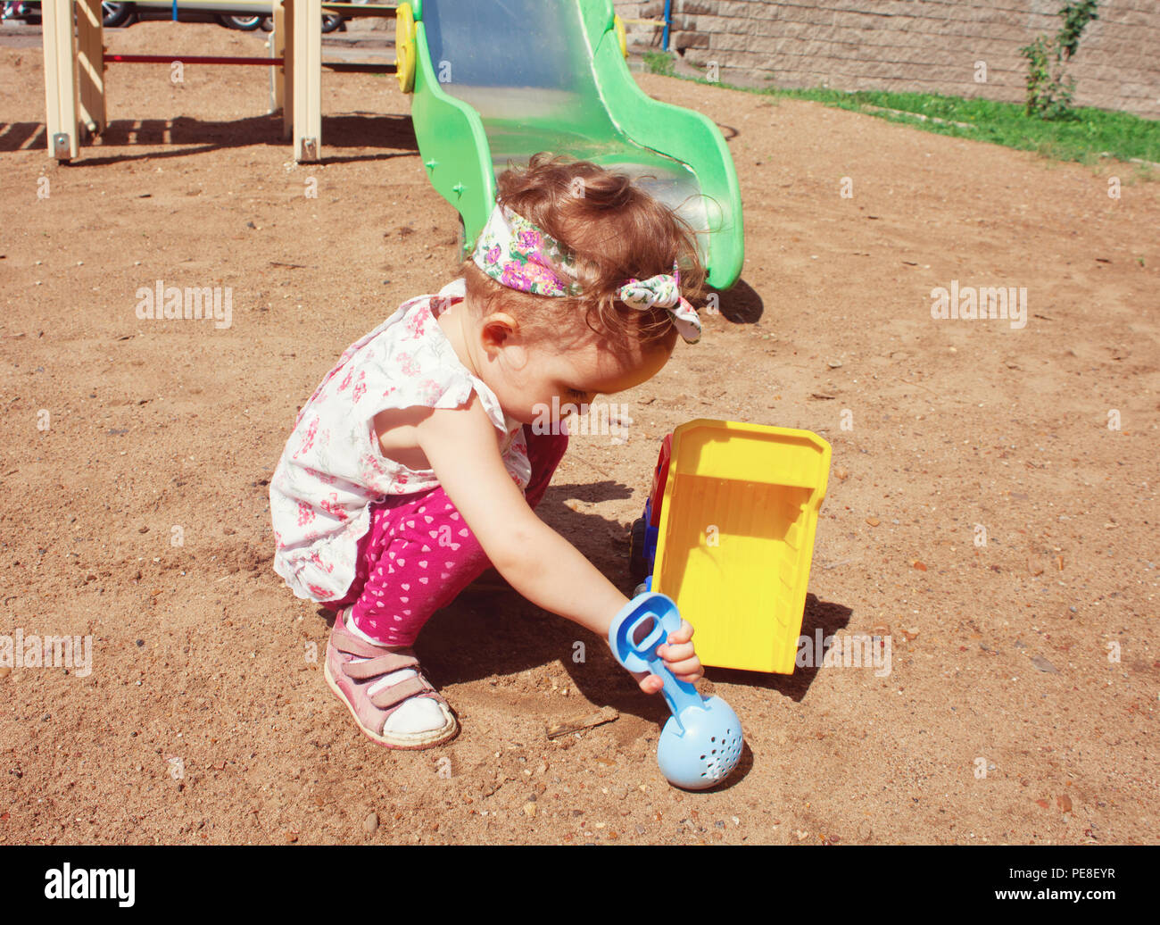 Beautiful little girl playing on tne playground Stock Photo - Alamy