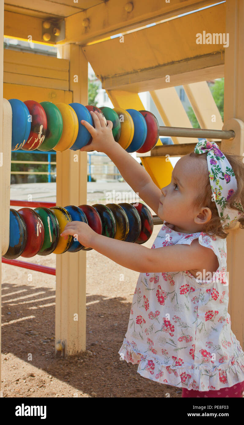 Beautiful little girl playing on tne playground Stock Photo - Alamy