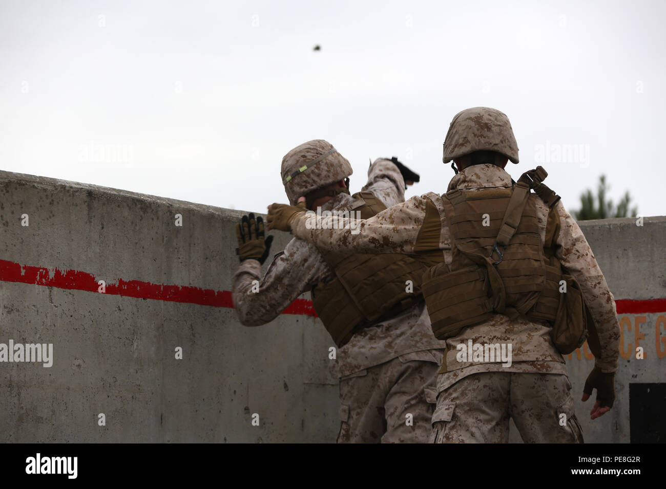Cpl. Justin Heslep, left, throws An M69 Practice Grenade as Cpl. Nathan