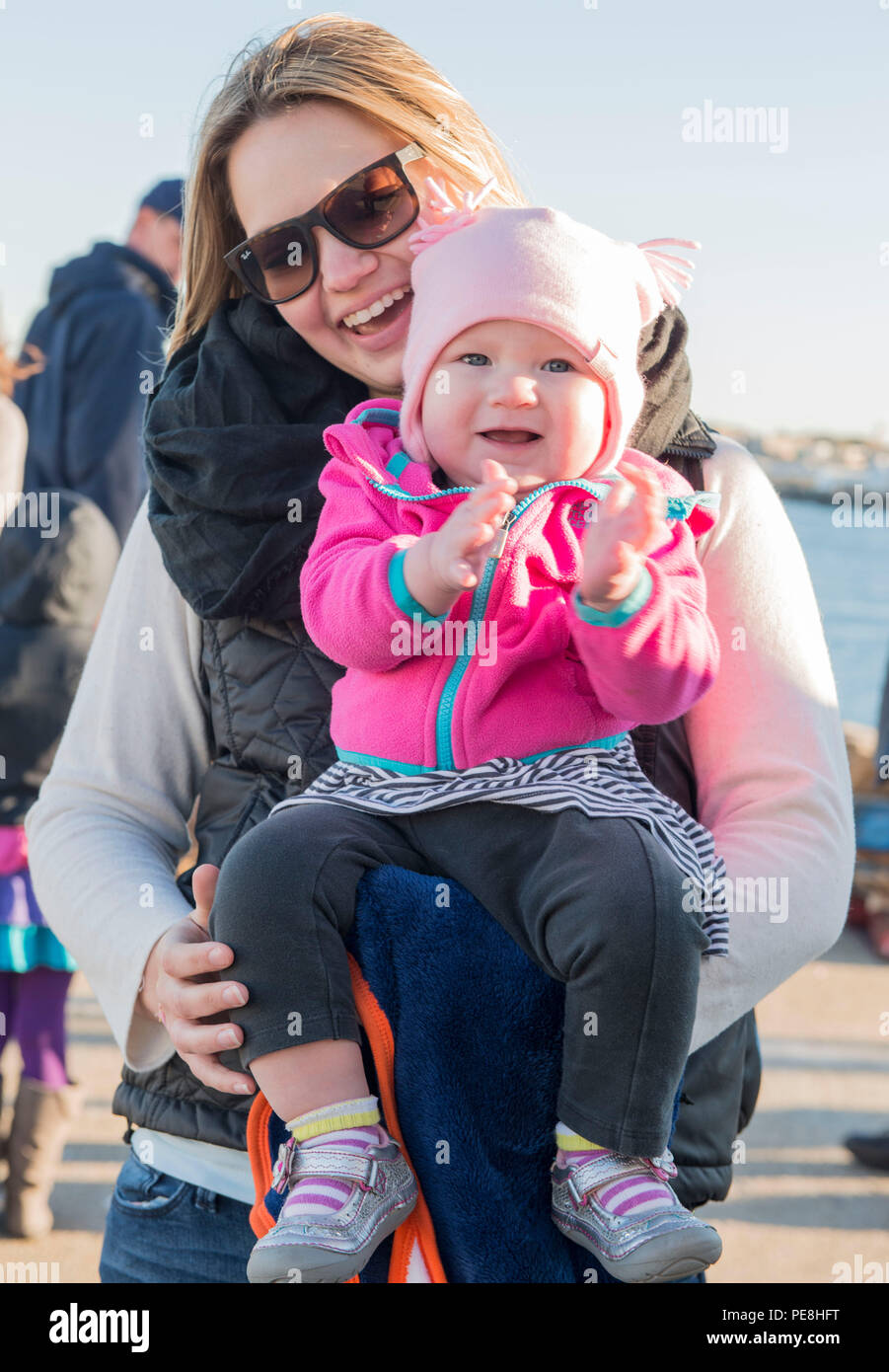 Lindsay Welch and her daughter Teagan wait for Lt. Steven Welch, the Operations Officer aboard the Coast Guard Cutter Spencer, while the cutter moors in Boston Friday, Oct. 30, 2015, after a 65-day patrol of the Caribbean Sea. During the patrol, Spencer’s crew intercepted four go-fast vessels suspected of trafficking drugs, and directly contributed to the seizure 2,204 pounds of marijuana and 13,697 of cocaine worth approximately $50 million. (U.S. Coast Guard photo by Petty Officer 2nd Class Cynthia Oldham) Stock Photo