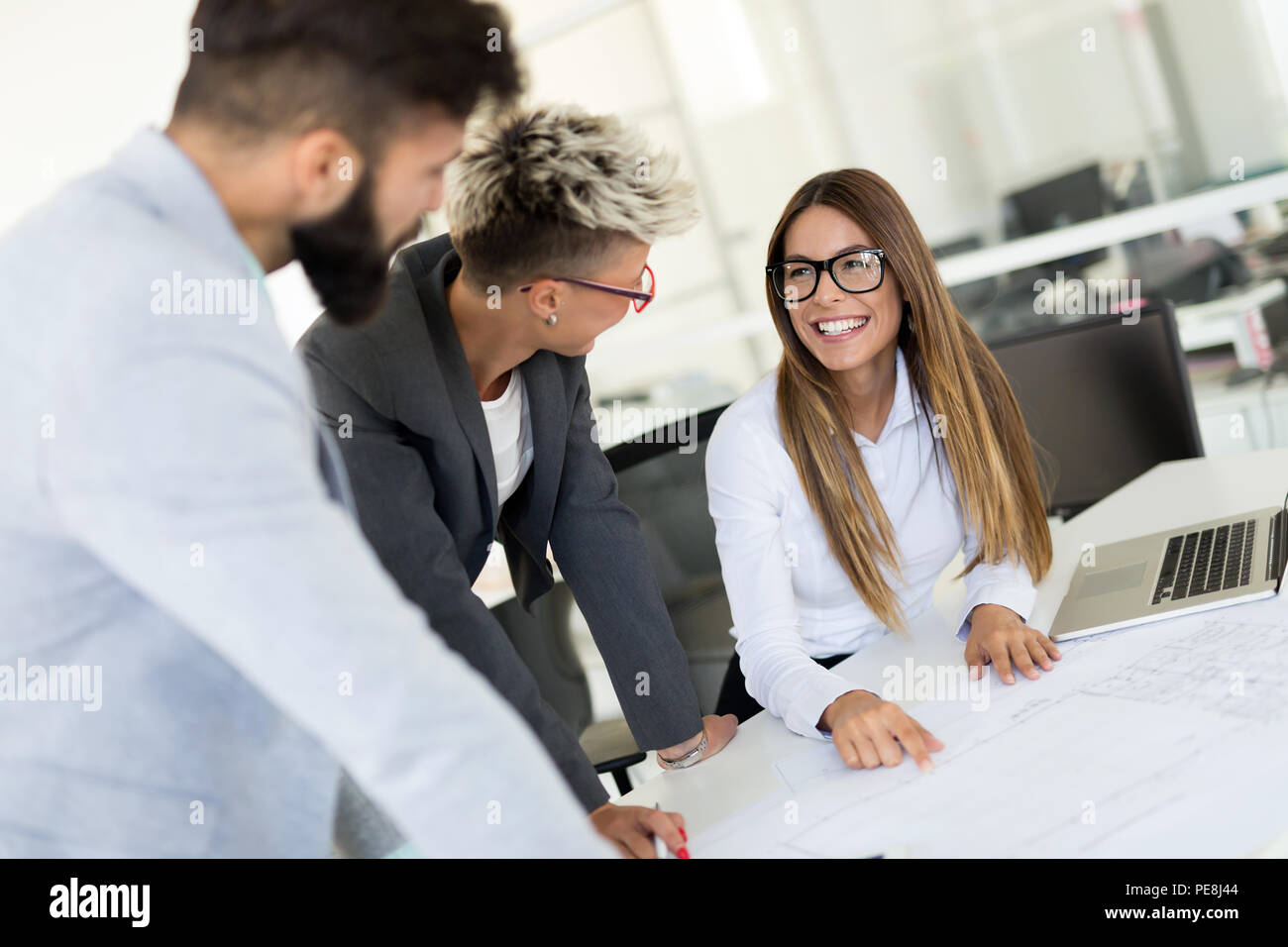 Picture of young architects discussing in office Stock Photo