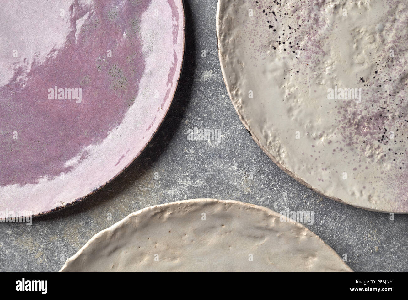 The porcelain vintage plates handmade on a gray marble table. Stock Photo