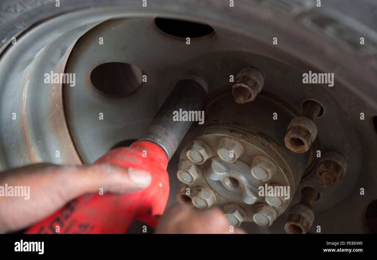 U.S. 5TH FLEET AREA OF OPERATIONS (Oct. 28, 2015) Constructionman Charles Tims, assigned to Commander, Task Group (CTG) 56.1, removes the lugnuts on a tire to check the brake pads on a truck during routine maintenance procedures in U.S. 5th Fleet area of operations Oct. 28, 2015. CTG 56.1 conducts mine countermeasures, explosive ordnance disposal, salvage-diving, and force protection operations throughout the U.S. 5th Fleet area of operations. (U.S. Navy photo by Mass Communication Specialist 2nd Class Shannon Burns/Released) Stock Photo