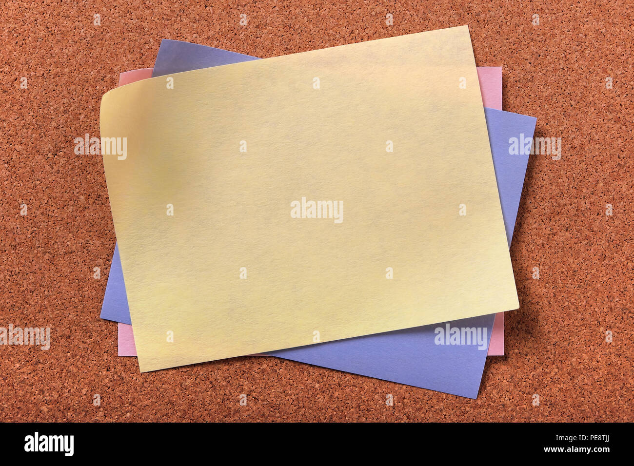 Yellow sticky post note various colors cork background Stock Photo