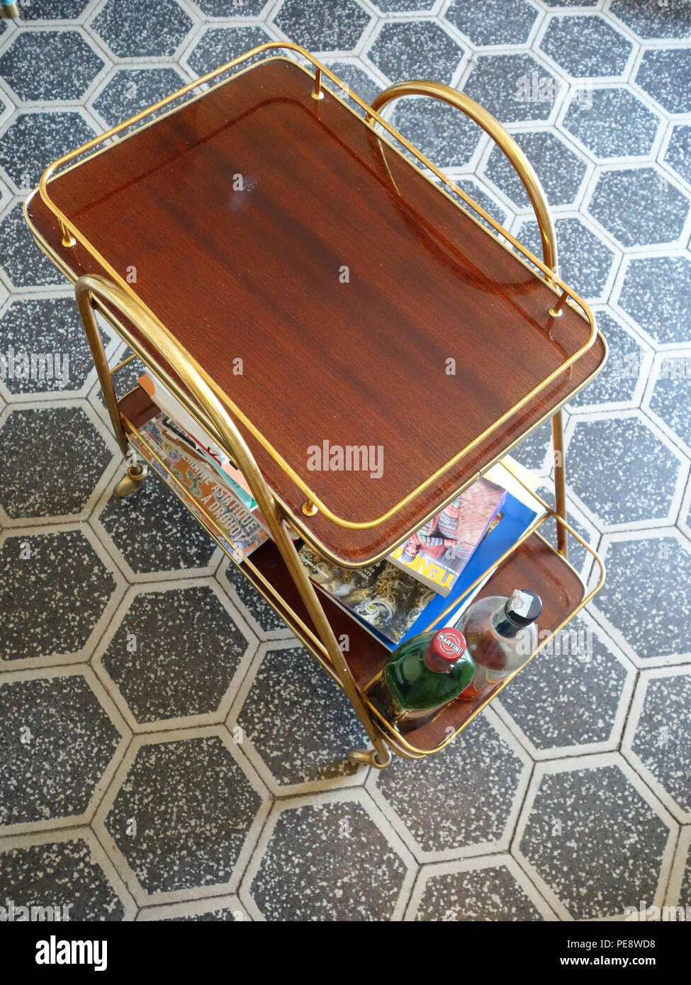 Looking down at a Vintage Art Deco Trolley Mid Century on a beautiful hexagon tiled floor in a large French house Stock Photo