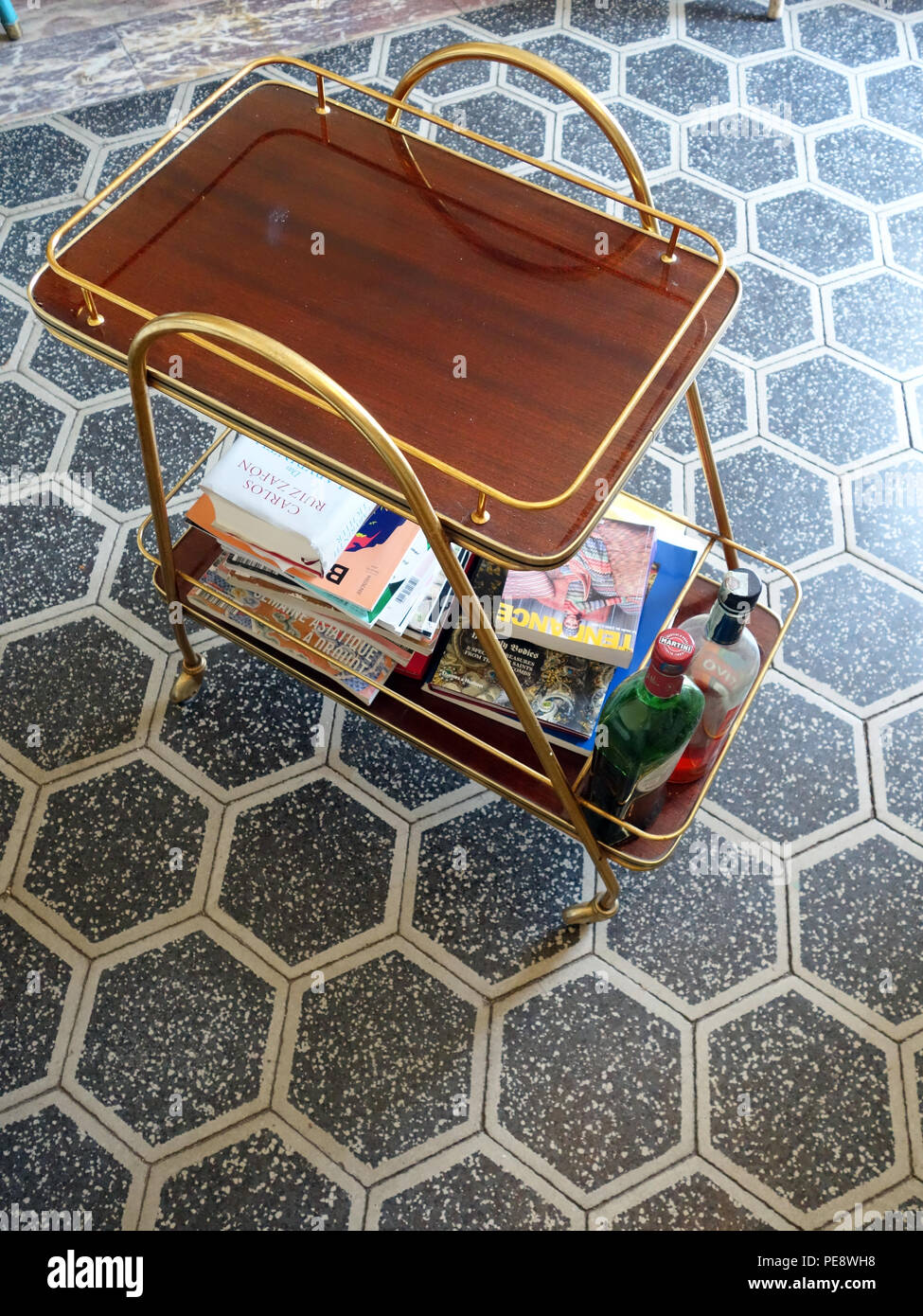 Looking down at a Vintage Art Deco Trolley Mid Century on a beautiful hexagon tiled floor in a large French house Stock Photo