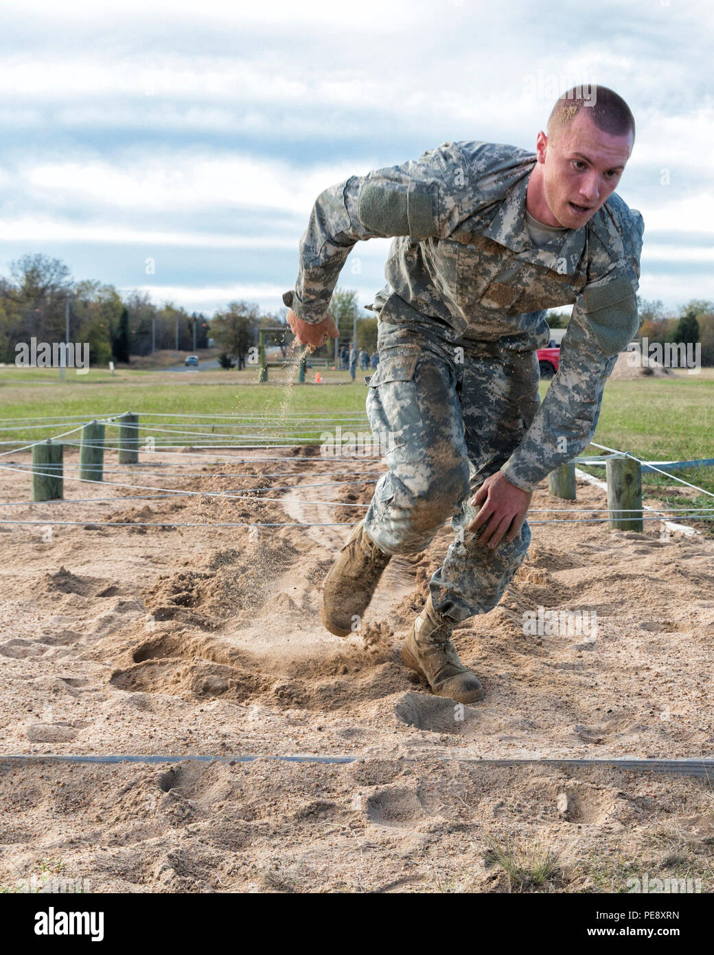 A Soldier maneuvers through an obstacle station during the Oklahoma ...