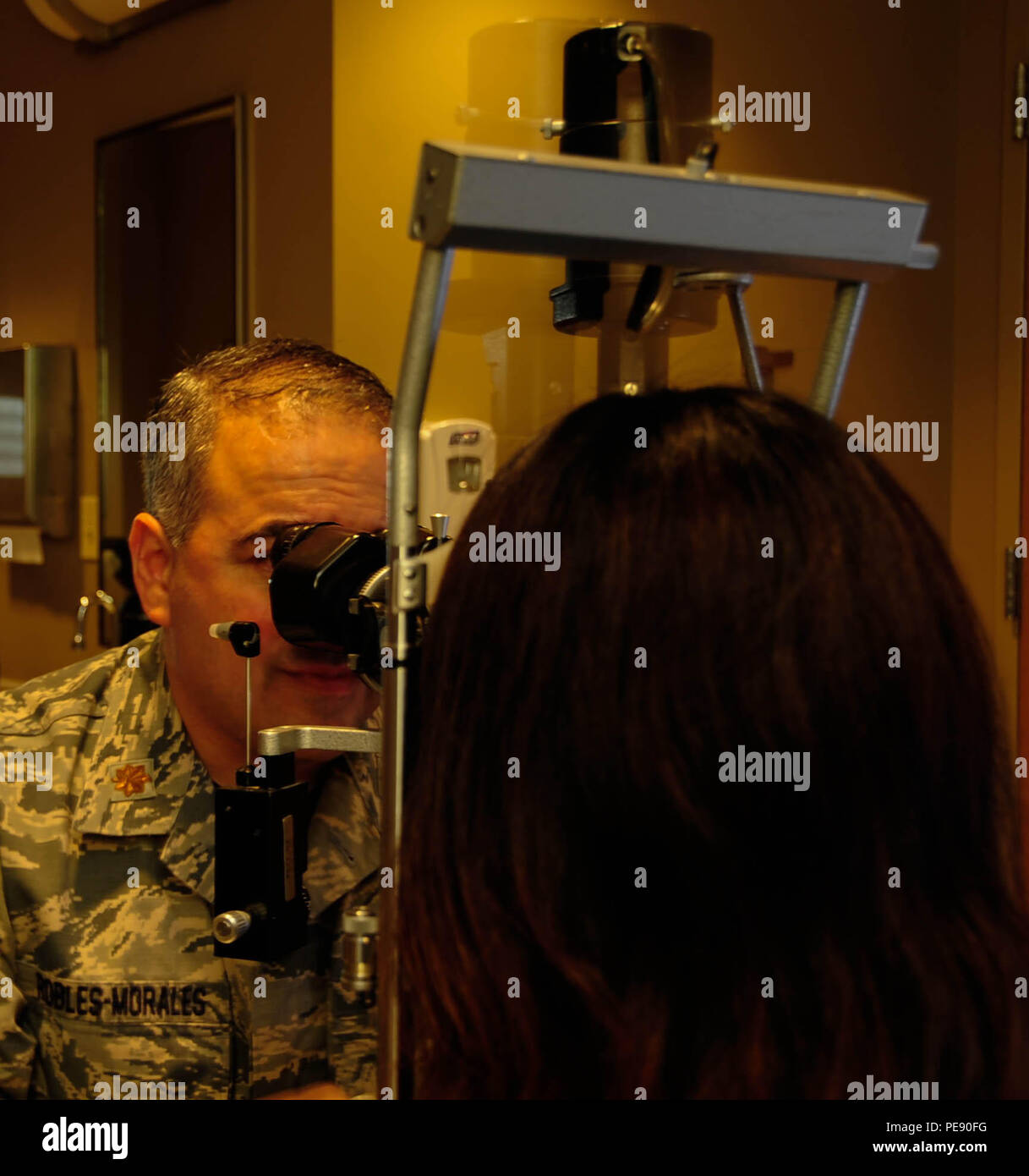 Maj. Gerardo I. Robles-Morales, 2nd Aerospace Medical Squadron Optometrist,  looks at Chizu McCasland's eye with a slit lamp at Barksdale Air Force Base,  La., Oct. 22, 2015. The slit lamp provides a