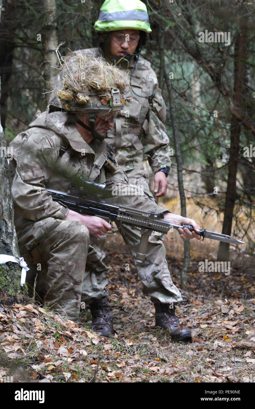 A British Army Royal Military Academy Sandhurst cadet (left) attaches ...