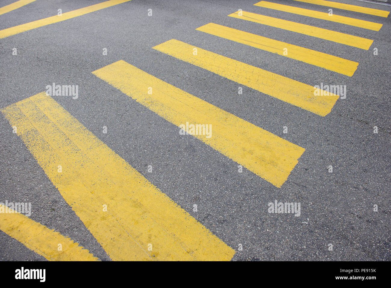 Yellow stripes of a city crosswalk Stock Photo - Alamy