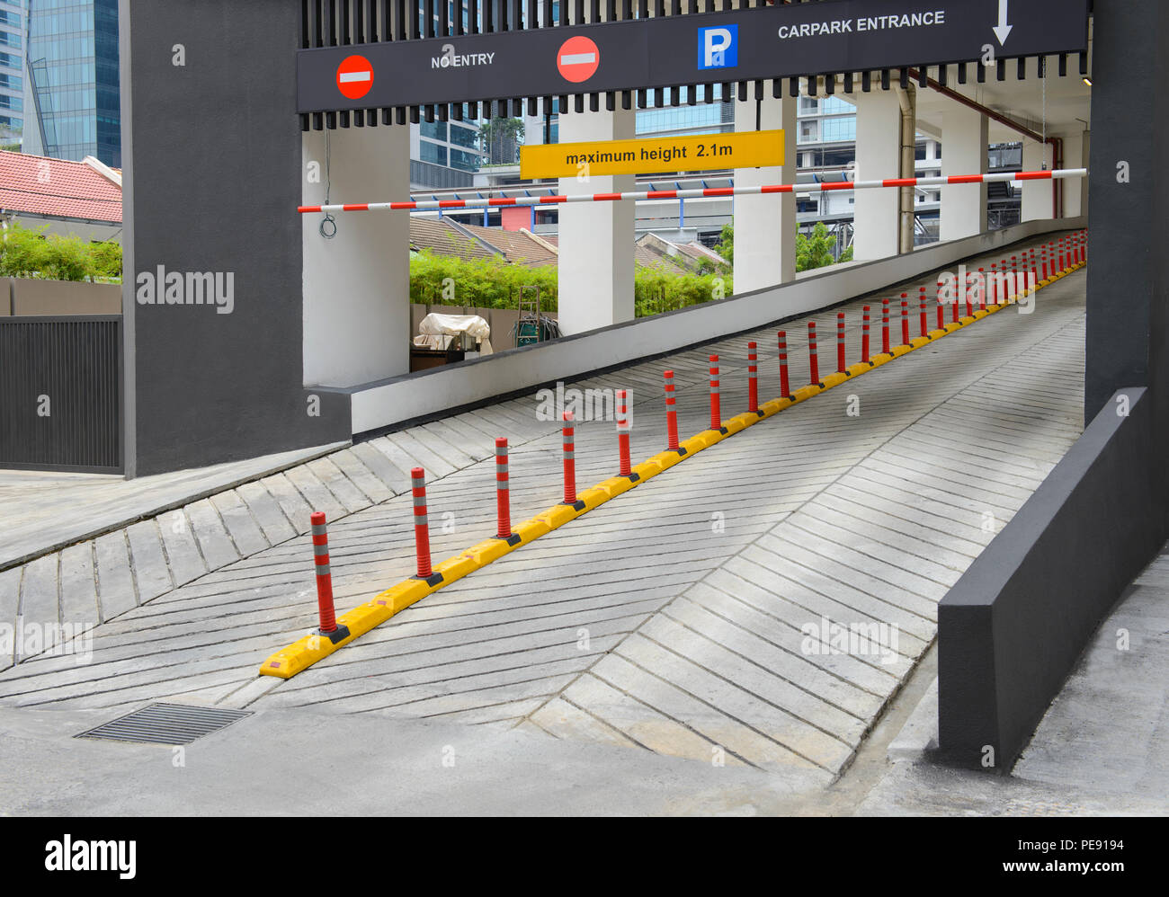 Entrance to car park ramp slope way on front of building Stock Photo ...