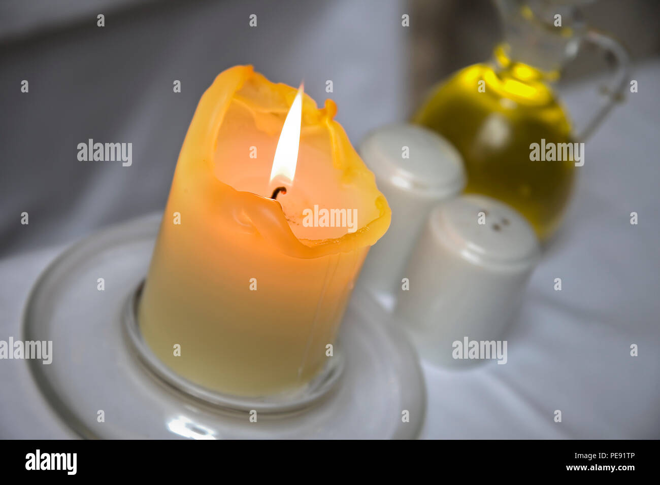 Burning candle with restaurant table setting Stock Photo Alamy
