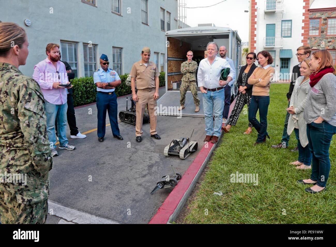 151104-N-HP195-168 LOS ANGELES -- Shane Brennan, center right, executive producer on 'NCIS: Los Angeles', expresses his appreciation for a Navy Explosive Ordnance Disposal demonstration on the back lot at Paramount Pictures in Hollywood. Brennan and other members of the show's writing staff hinted that the technology demonstration provided by EOD Mobile Unit Eleven could inform future episodes of 'NCIS: Los Angeles'. The meeting was coordinated by the Navy Office of Information West (NAVINFOWEST), which provides production assistance to entertainment industry professionals and helps them becom Stock Photo