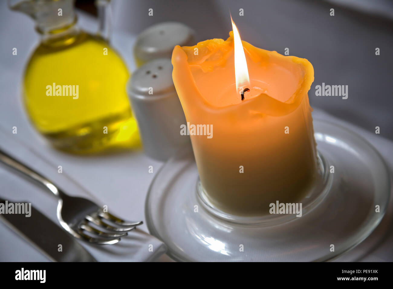 Burning candle with restaurant table setting Stock Photo Alamy