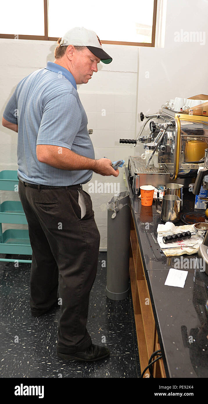 SINGAPORE - Navy Region Center Singapore Food and Beverage Director, Charles Mecke, busily prepares espresso coffee drinks during the grand opening of Cafe Lah, Nov. 9, 2015.  The new establishment is part of an allied military venture to promote community use for allied military service members and their families serving in Sembawang, Singapore. (Official U.S. Navy photo by Marc Ayalin) Stock Photo