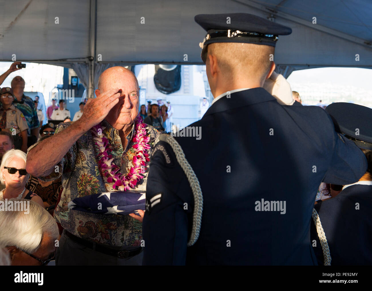 151111-N-ON468-260 PEARL HARBOR (Nov. 11, 2015) Retired Air Force Col. Jack Detour, left, salutes Joint Base Pearl Harbor-Hickam Air Force Honor Guard member Airman 1st Class Joshua Namio, after receiving an American flag that flew over the USS Missouri on Veterans Day 2015. Detour had the distinction of serving in World War II, the Korean War and the Vietnam War during his military career. The flag presentation was part of a Veterans Day sunset ceremony aboard the Battleship Missouri Memorial, in honor and remembrance of the 70-year anniversary of the end of World War II and the 40-year anniv Stock Photo