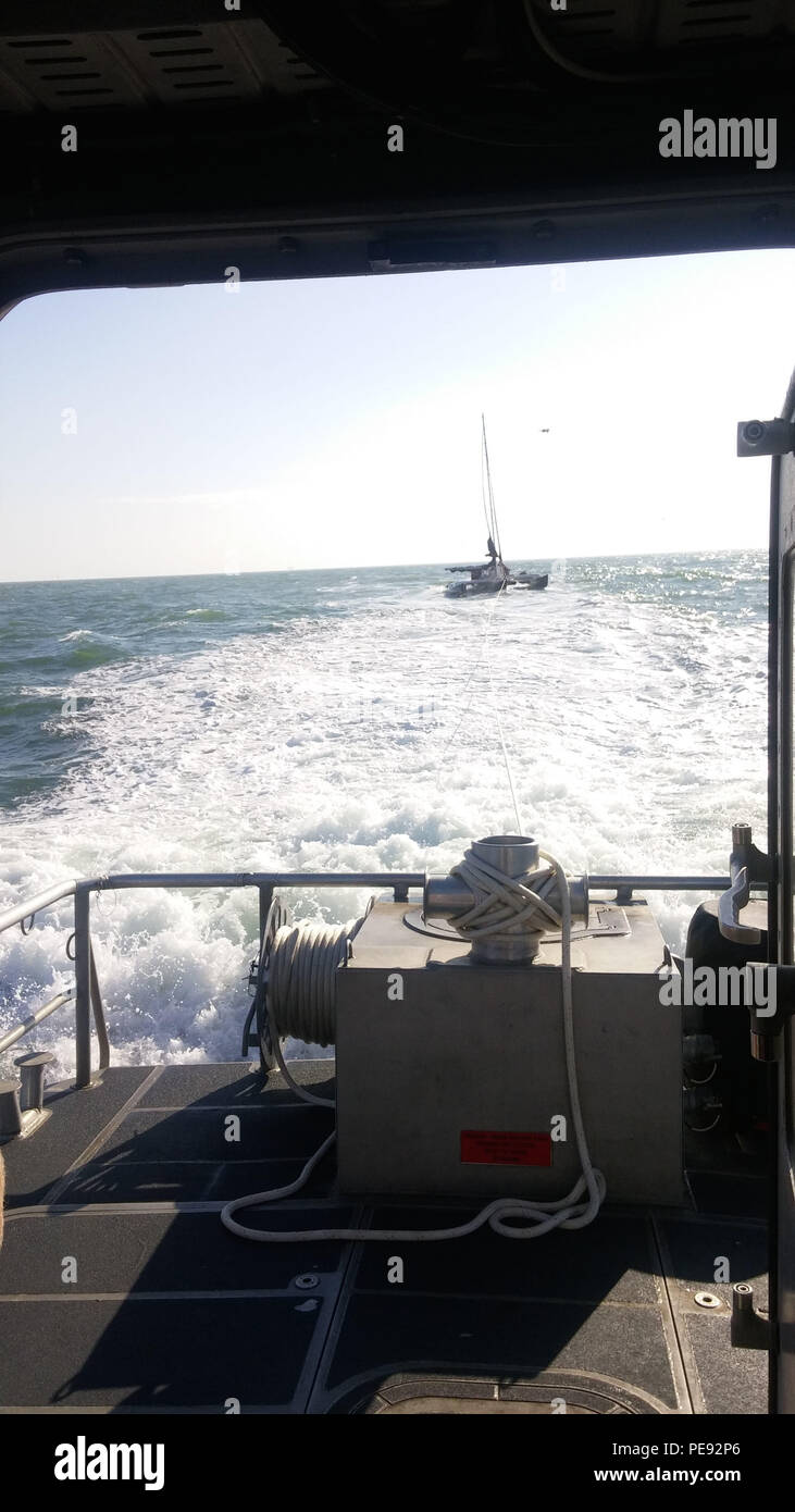 A Coast Guard Station Galveston boat crew continues towing a disabled 40-foot trimaran off Galveston, Texas, Wednesday, Nov. 11, 2015. The boat became disabled hundreds of miles from shore and was towed most of the way by a tanker that was able to assist, then the Coast Guard crew towed them in range of commercial assistance. (U.S. Coast Guard photo.) Stock Photo