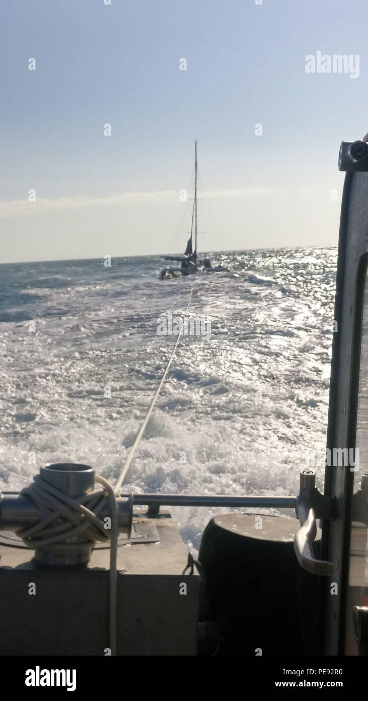 A Coast Guard Station Galveston boat crew continues towing a disabled 40-foot trimaran off Galveston, Texas, Wednesday, Nov. 11, 2015. The boat became disabled hundreds of miles from shore and was towed most of the way by a tanker that was able to assist, then the Coast Guard crew towed them in range of commercial assistance. (U.S. Coast Guard photo.) Stock Photo