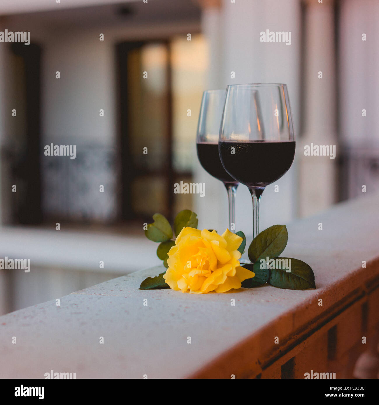 Download Two Glasses Of Red Wine On The Balcony With A Yellow Rose Stock Photo Alamy Yellowimages Mockups