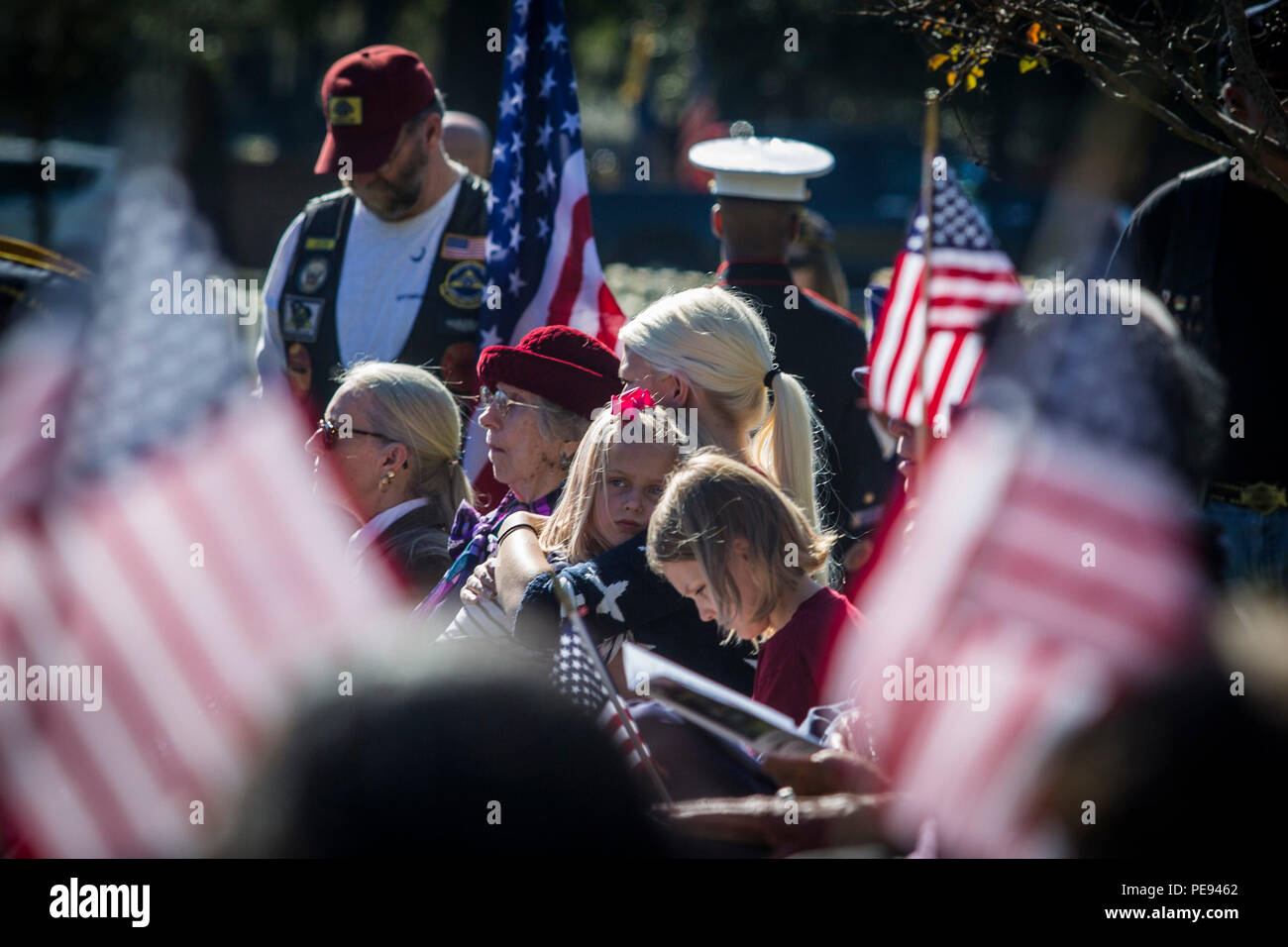 Visitors observe a moment of silence during a Veterans Day ceremony at