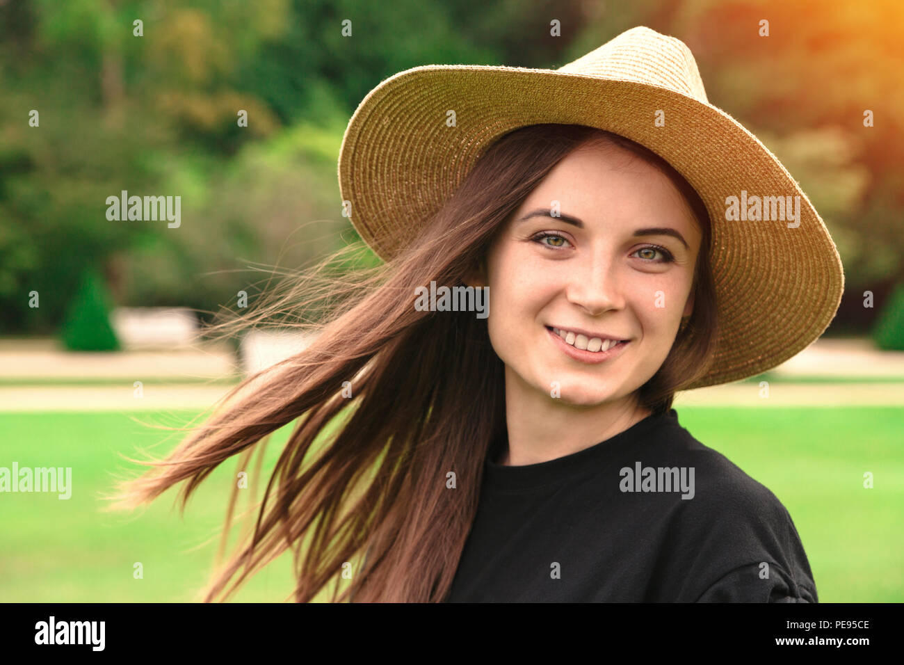 Young beautiful woman in straw hat in park in summer Stock Photo - Alamy
