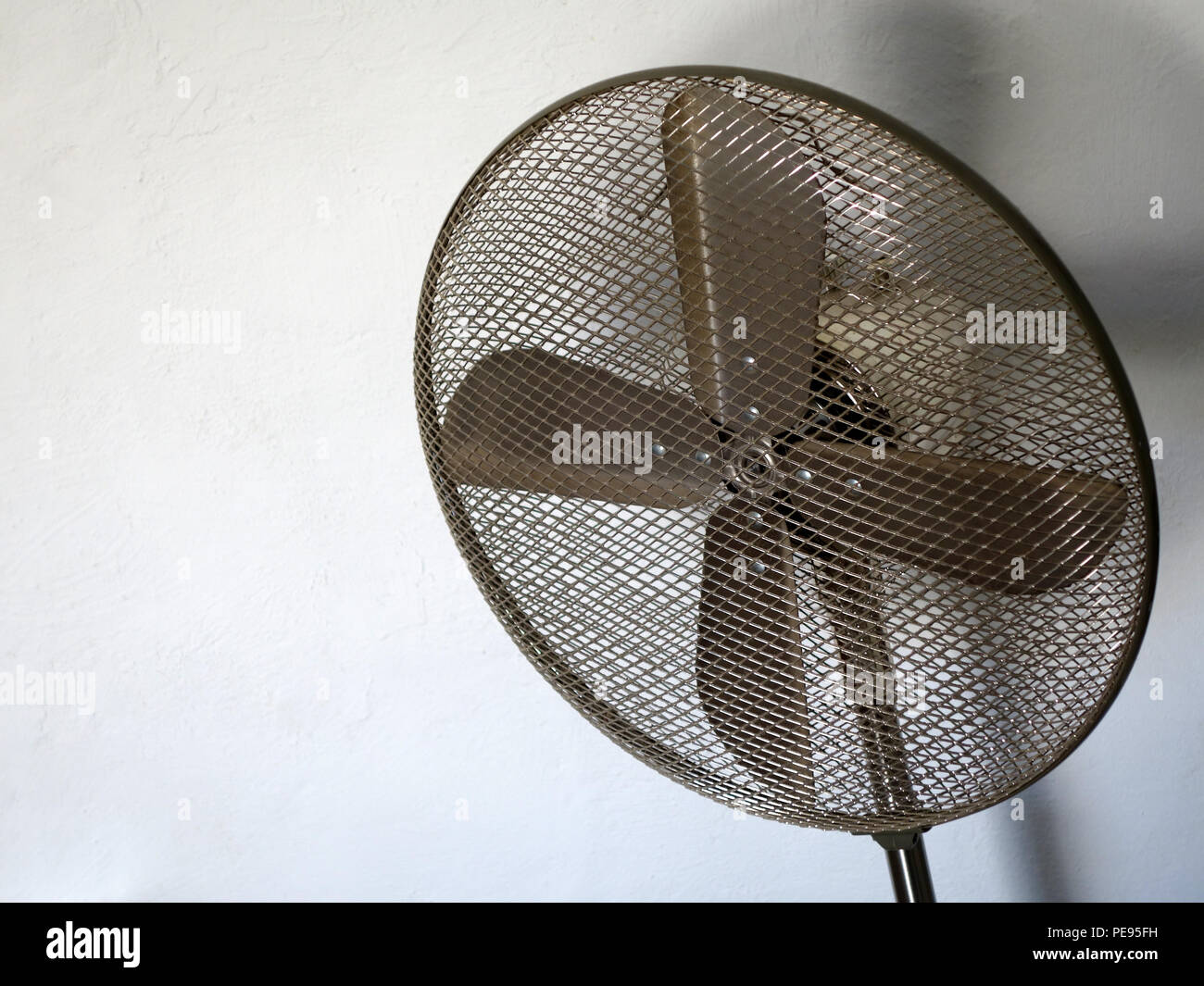 Black mesh cover on an electric cooling fan Stock Photo Alamy