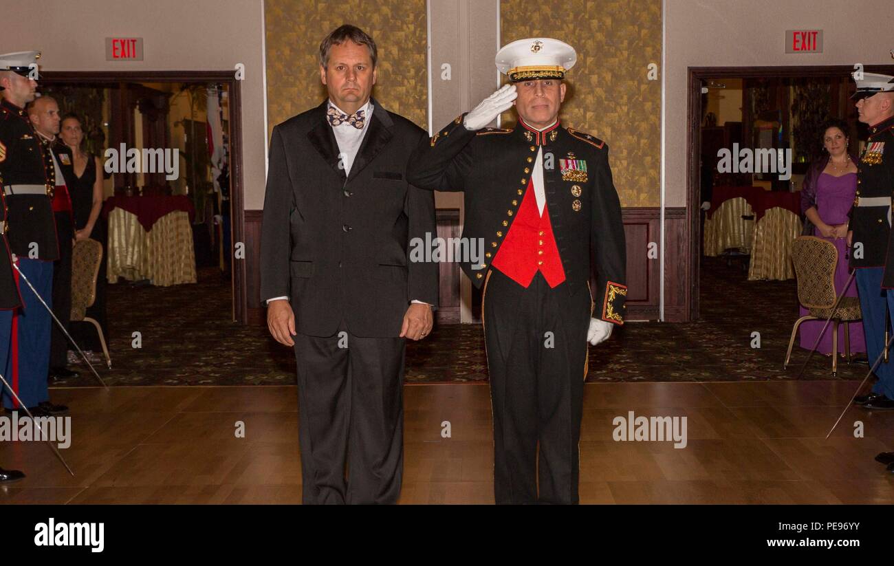 U.S. Consul General, Naha Joel Ehrendreich and Brig. Gen. Joaquin F. Malavet march to the center of the ballroom and pause for a salute from the sword detail before taking their place in front for the entry of the birthday cake for the 240th Marine Corps Birthday Ball November 13, 2015 at the Butler Officers Club on Camp Foster Okinawa, Japan. The Marine Corps Ball has been a Marine Corps tradition since 1951 and continues to be a time every year where current Marines set aside an evening to honor fallen Marines and toast to the future success of the Corps. The ball ceremony includes a sword d Stock Photo