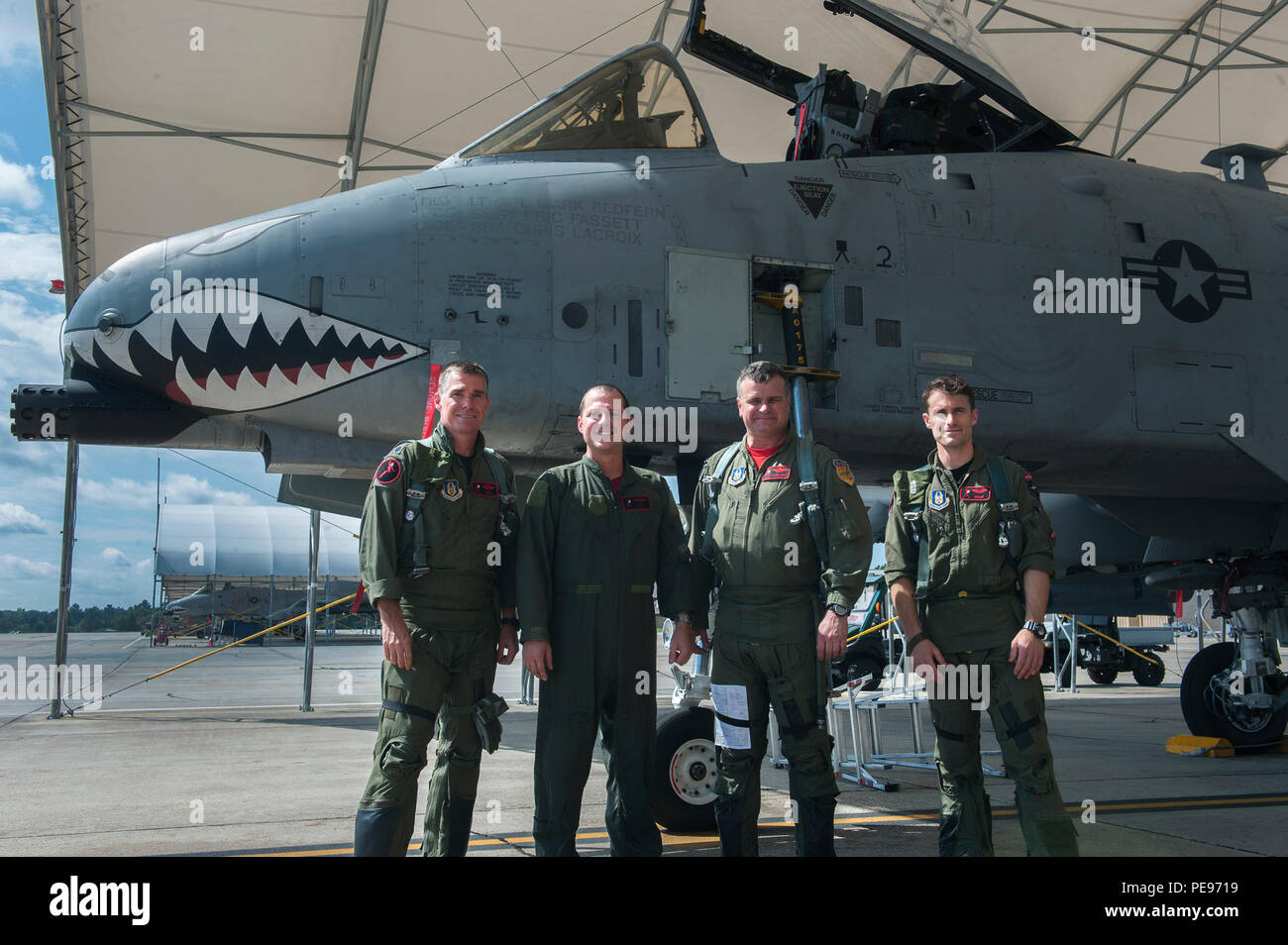 U.S. Air Force Col. James Travis, 476th Fighter Group commander, poses for a photo with members of his flight formation in front of an A-10C Thunderbolt II after his fini-flight Sept. 11, 2015, at Moody Air Force Base, Ga. The final flight, also known as a “fini-flight,” has been a tradition for departing or retiring pilots or commanders since the Vietnam War. (U.S. Air Force photo by Airman 1st Class Kathleen D. Bryant/Released) Stock Photo