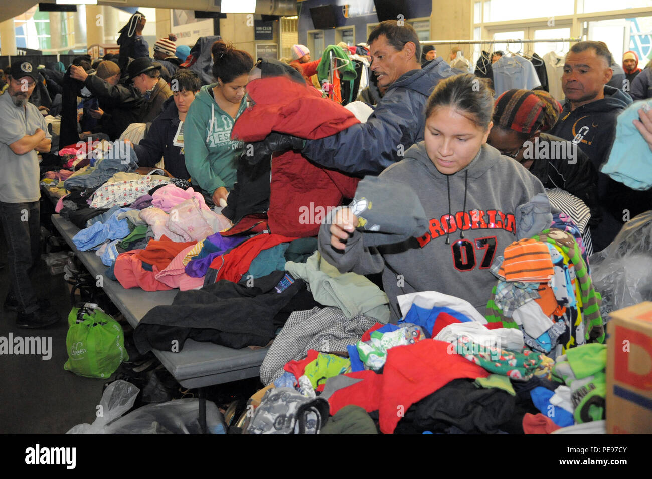 Utah residents receive donated winter clothing Nov. 16 at Vivint Smart Home Arena, Salt Lake City, Utah. The 17th annual community outreach event called 'We Care-We Share' helped thousands in the greater Salt Lake City community. (U.S. Air Force photo by Todd Cromar) Stock Photo