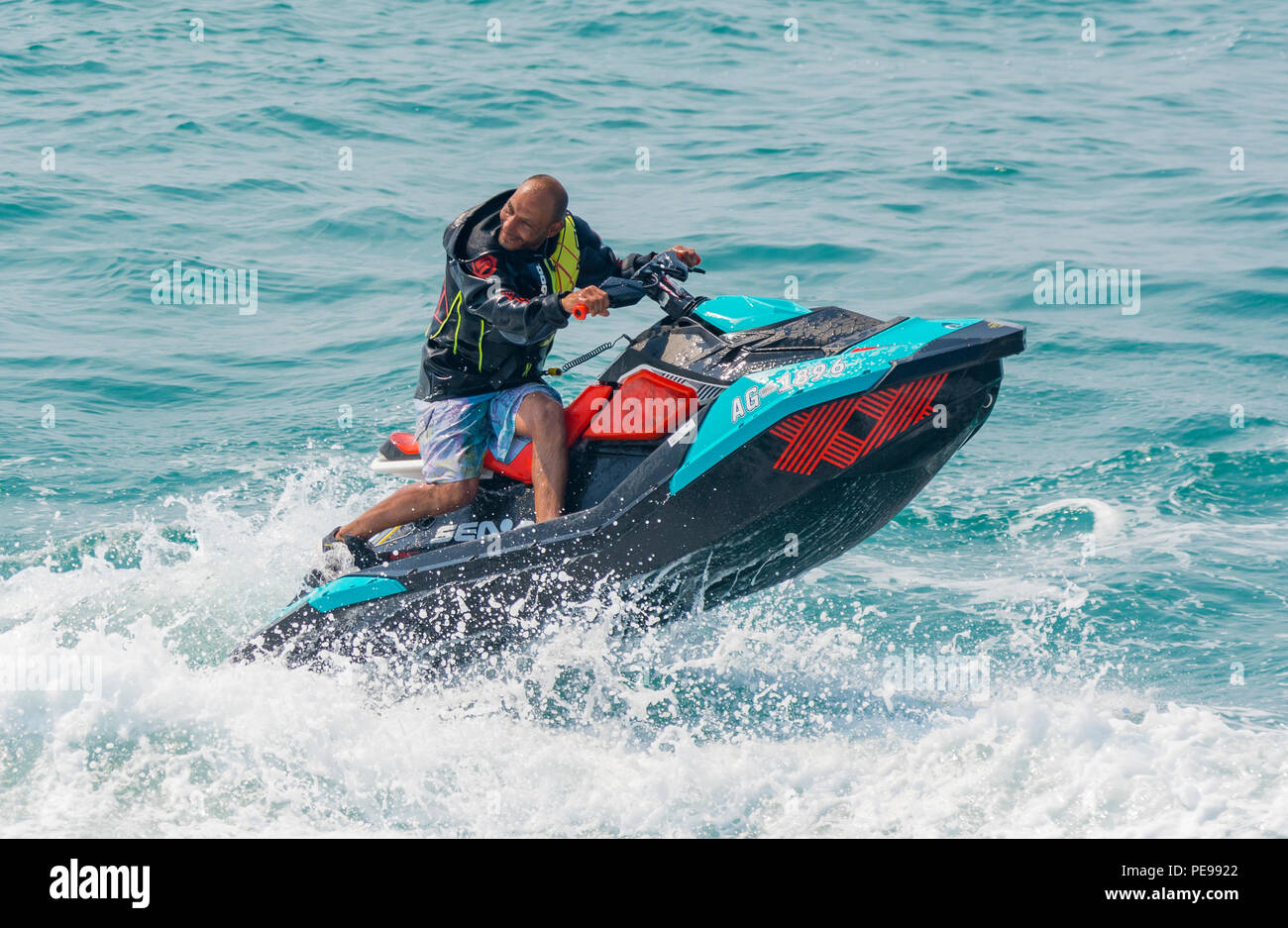 A man riding a jet ski on the sea.in Summer in the UK. Jet ski. Jet skiing. Stock Photo