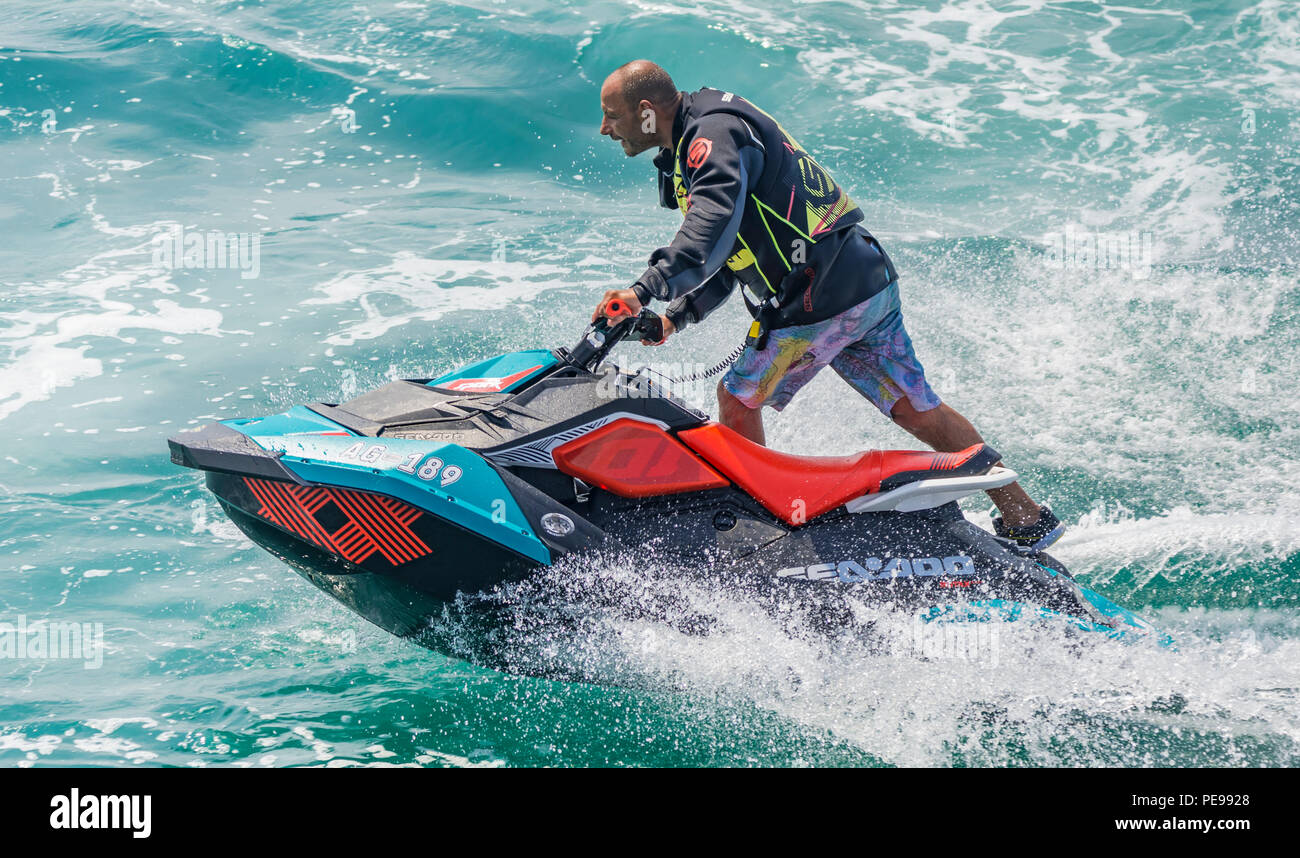 Man riding a jet ski on the sea in Summer in the UK. Water sports. Jet skiing. Jet ski. Stock Photo