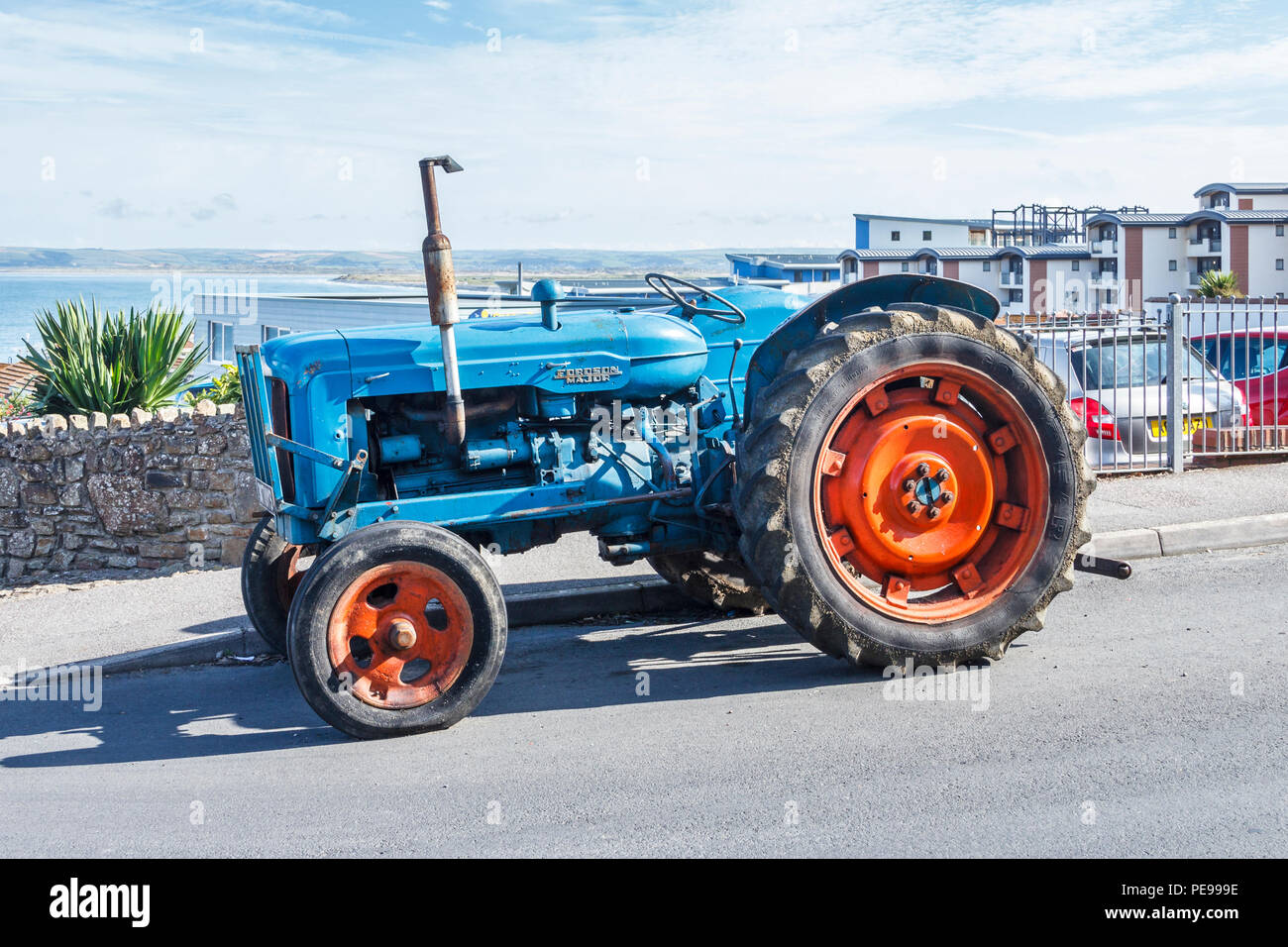 Old blue Fordson Major tractor with red wheels in Westward Ho!, Devon, UK Stock Photo