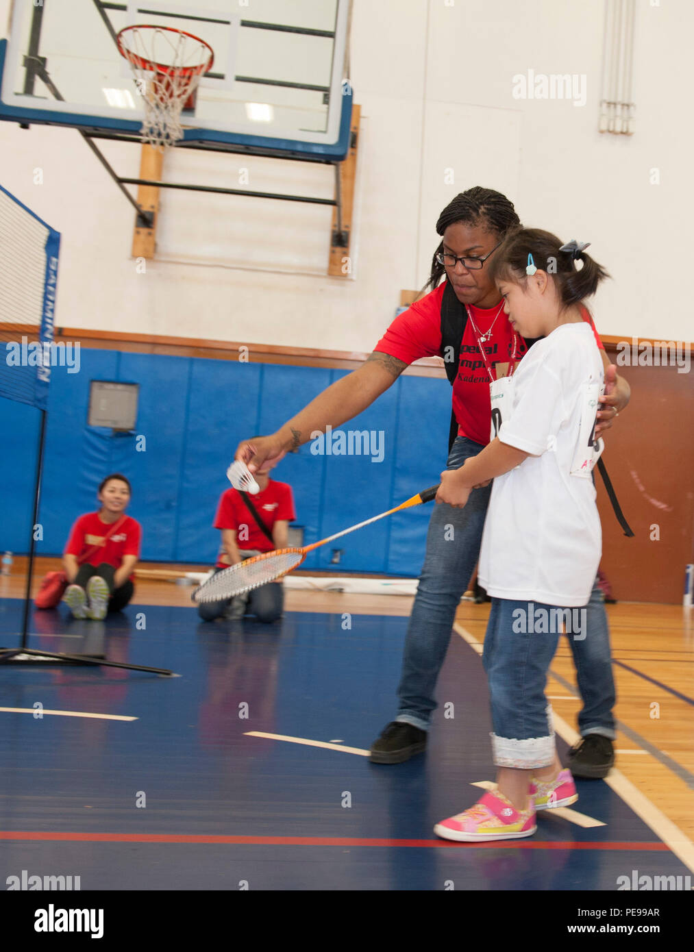 U.S. Air Force Airman 1st Class Amiya Jones, 18th Security Forces Squadron armorer, helps Yuri Yonaha, a Kadena Special Olympics athlete, with her badminton skills during the Kadena Special Olympics, Nov. 7, 2015, at Kadena Air Base, Japan. This year marks the 16th anniversary of KSO, a sporting event dedicated to enriching the lives of American and Okinawan special needs individuals on the island. (U.S. Air Force photo by Airman 1st Class Lynette M. Rolen) Stock Photo