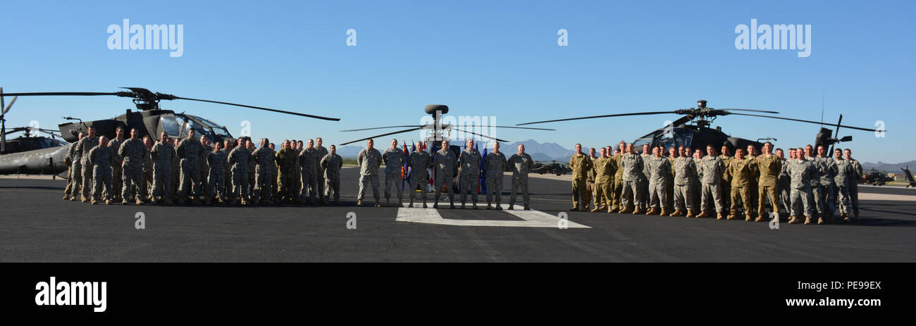 Gunfighter Fly-in competition participants take a group photo in front of  AH-64D Apache helicopters Nov. 6 at Silverbell Army Heliport in Marana,  Ariz. The Arizona National Guard hosted the inaugural competition that