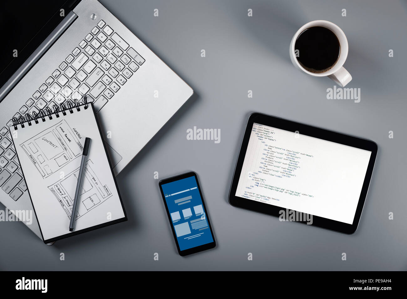 website development in process. wireframe sketch and programming code Stock Photo