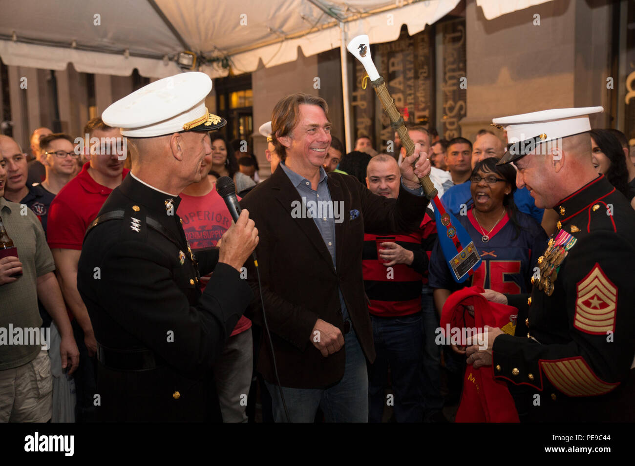 Lt. Gen. Rex C. McMillian (left), commander of Marine Forces Reserve, and Sgt. Maj. Anthony A. Spadaro (right), sergeant major of MARFORRES, present John Besh, chef and former Marine sergeant, with a commemorative paddle at Luke Restaurant in New Orleans, Nov. 10, 2015. The gift was given to thank Besh for hosting this event at his restaurant to celebrate the 240th Marine Corps Birthday. (U.S. Marine Corps photo by Cpl. Ian Leones/Released) Stock Photo